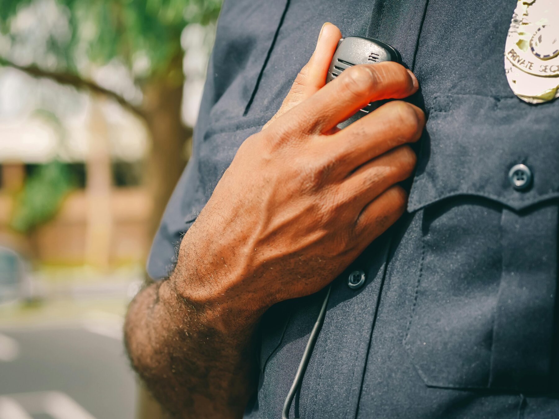 A Chicago police officer holding his radio. 