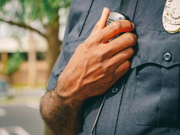 A Chicago police officer holding his radio.